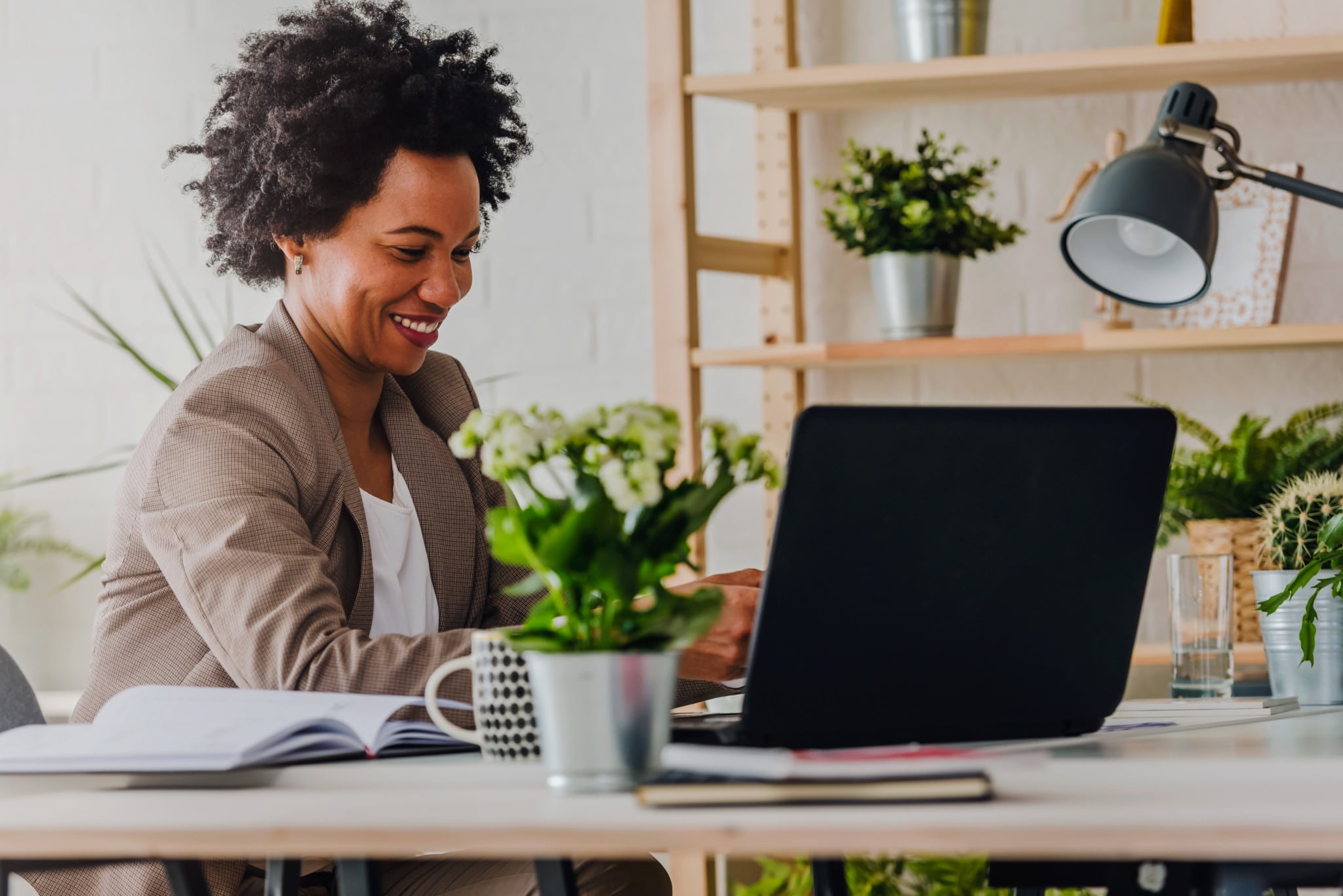 working business woman with a computer and plants