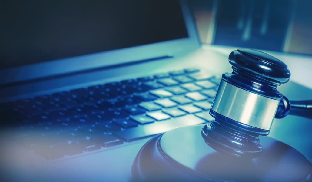 This image shows a gavel and a laptop as cybersecurity is important for law firms.