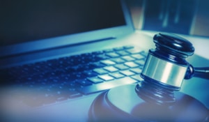 This image shows a gavel and a laptop as cybersecurity is important for law firms.