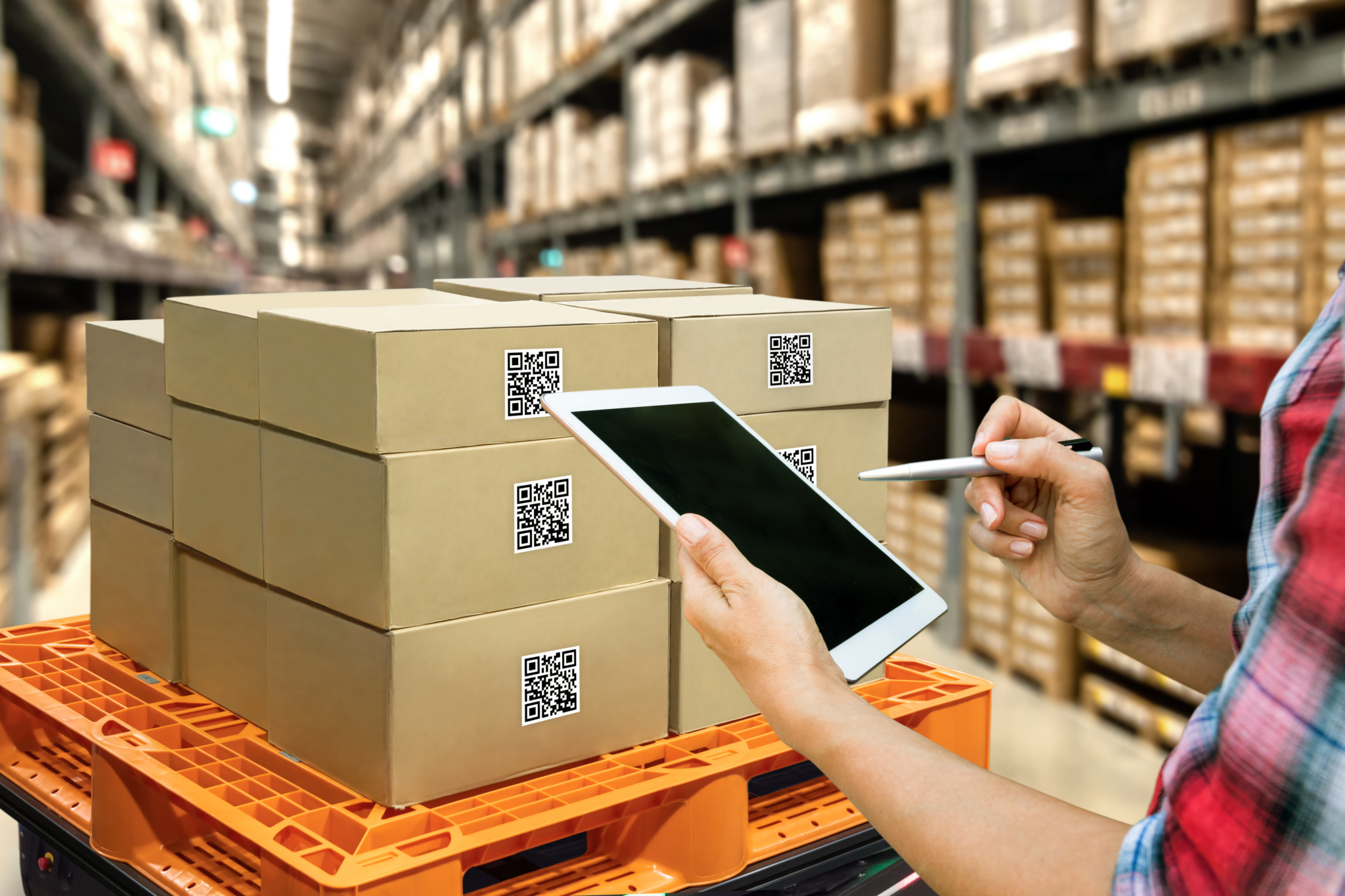 A warehouse worker managing supply chain risks